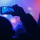 Person holding smartphone at an event